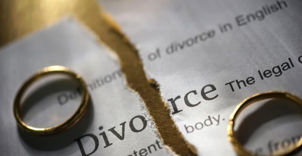 divorce-paper-torn-in-half-with-two-wedding-bands-on-each-side